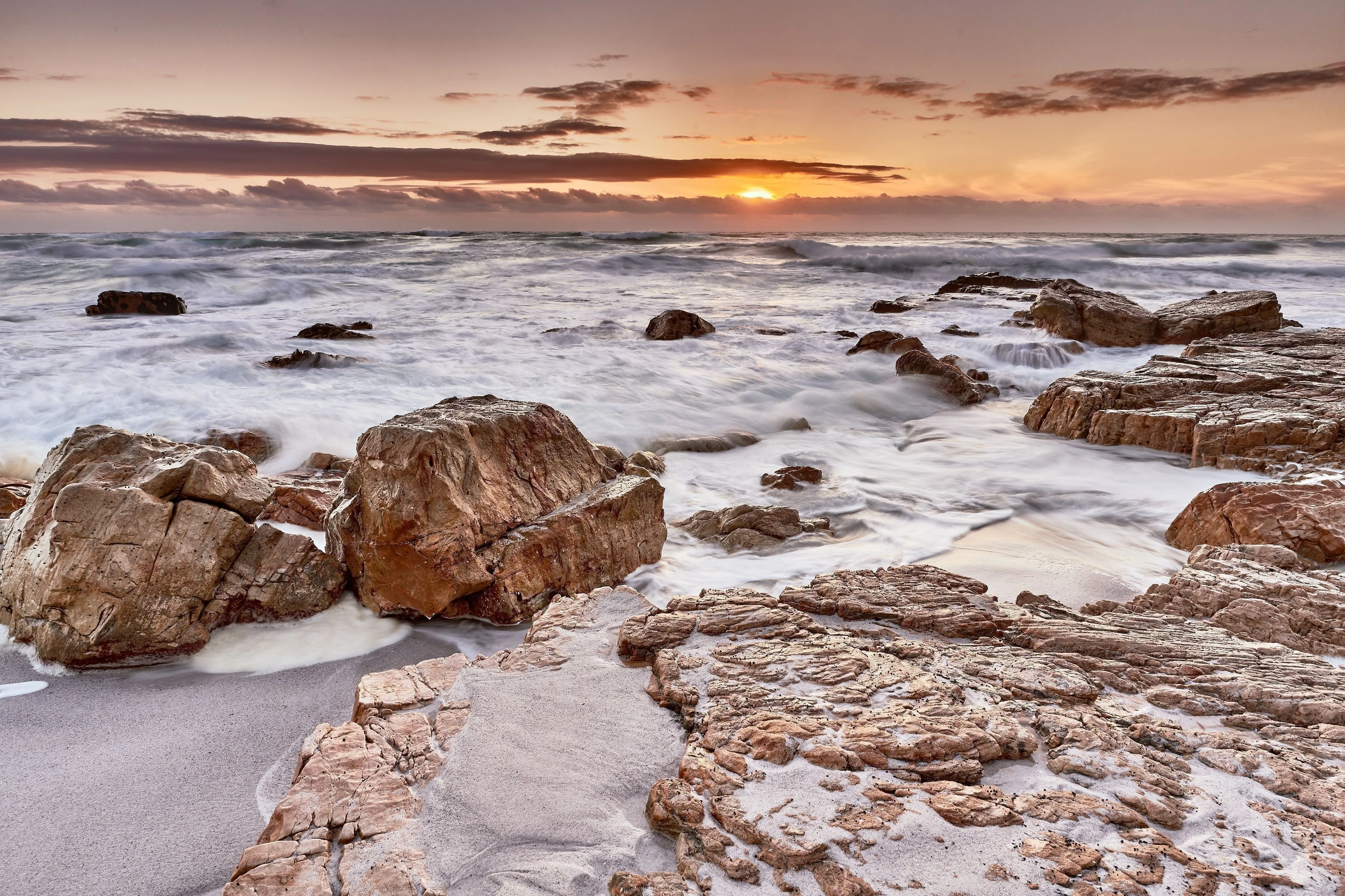 Dramatic seascape with waves crashing against rocky coastline